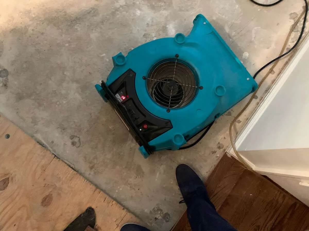 Air mover drying subfloor during Commercial Water Damage Restoration in Maplewood
